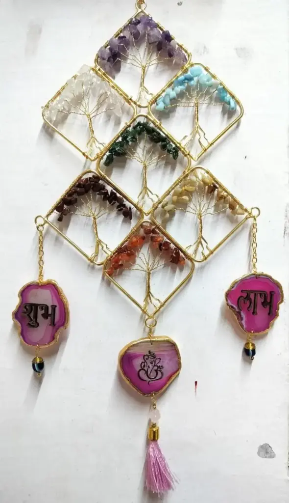 a crystal decorative wall hanging or toran, which is a type of embellishment often used to decorate the entrance or walls of a home.